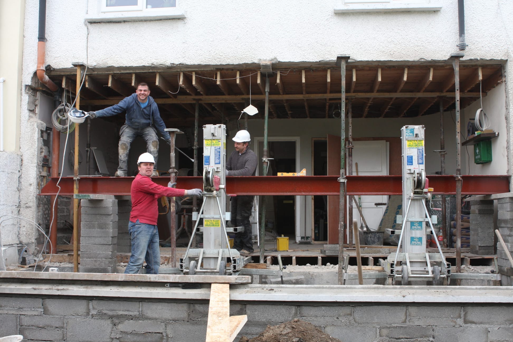 Team installing structural steel beam